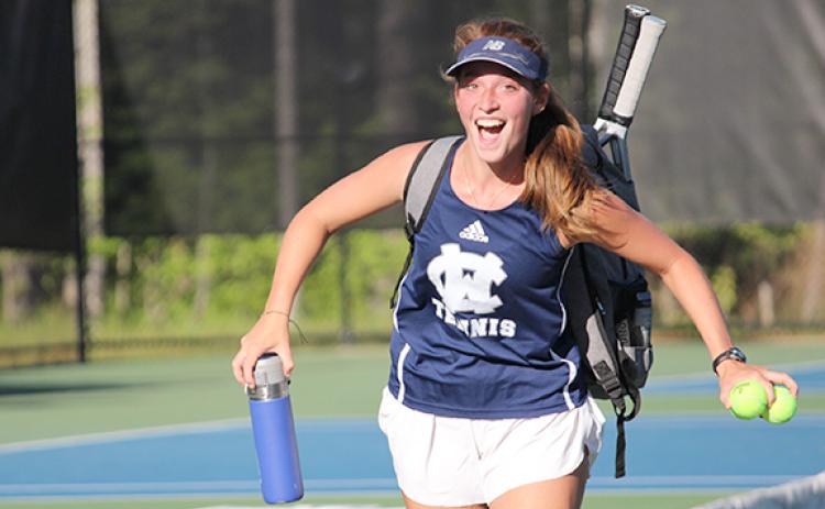 Aubrey Bolton celebtates after winning her match to clinch the Lady Warriors' win in the second round of the state tournaent Monday at the TMU tennis facility. (Photo/Mark Turner)