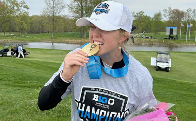 Caroline Craig takes a bite out of the Big Ten medal following the tournament win. (Photo/Submitted)