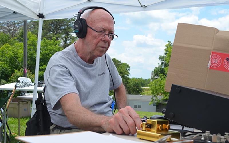 Alan Sykes uses a Morse code panel to try to reach other amateur radio operators, known as hams, during the exercise. (Photo/Samantha Sinclair)